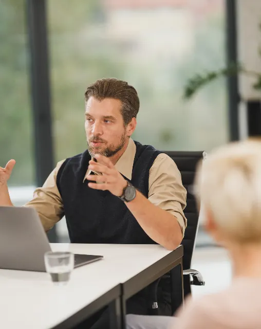 Business meeting around a table with a laptop
